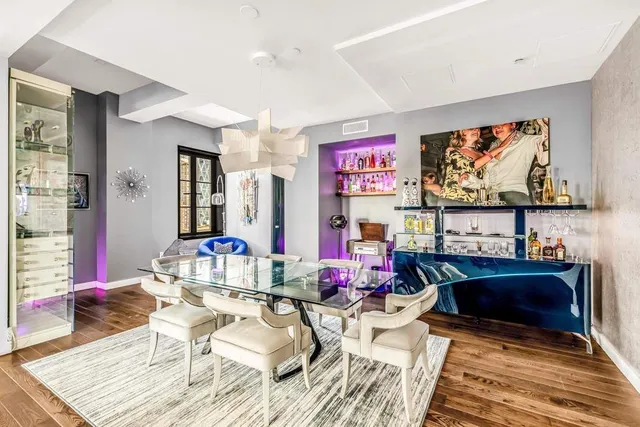 a living room with furniture flat screen tv and a window