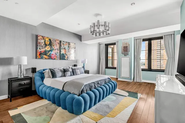 a room with a table chairs wooden floor and windows