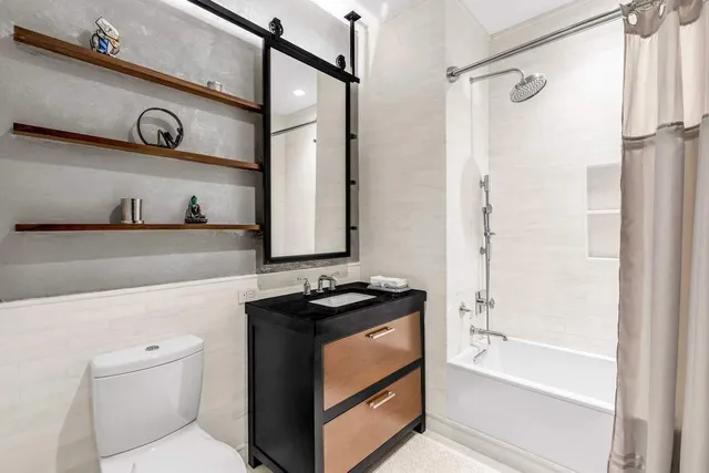 a bedroom with a bed and painting on the wall