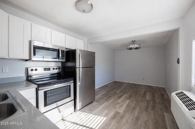 a kitchen with a refrigerator stove and microwave