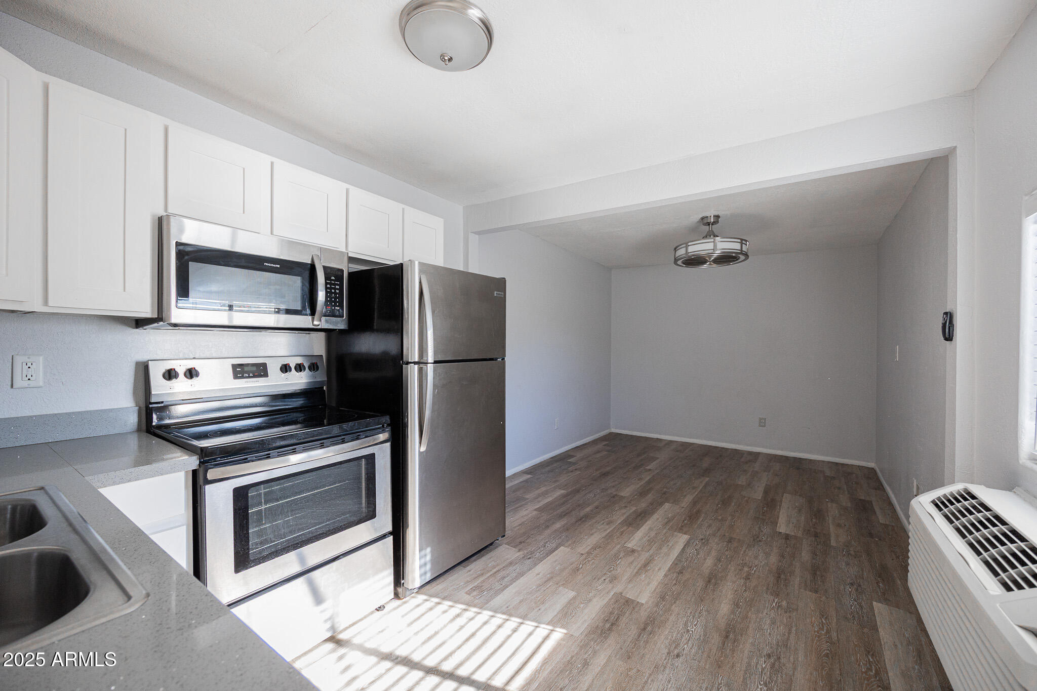1026 East Pierce Street, Unit B Phoenix, AZ 85006 - Photo 12 of 14 a kitchen with a refrigerator stove and microwave