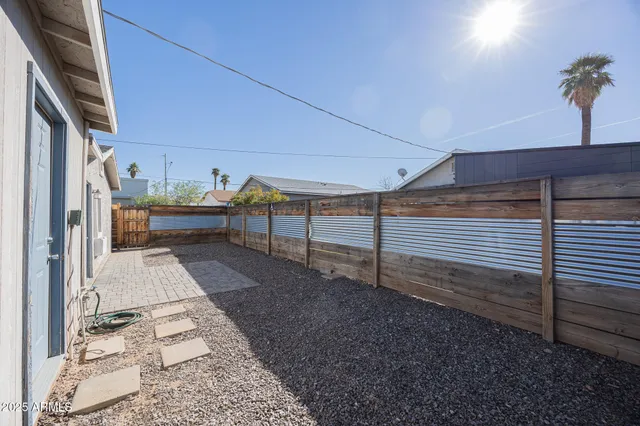 a view of a backyard with sitting area