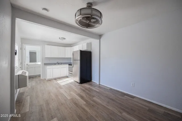a view of a kitchen with a sink wooden floor and a window