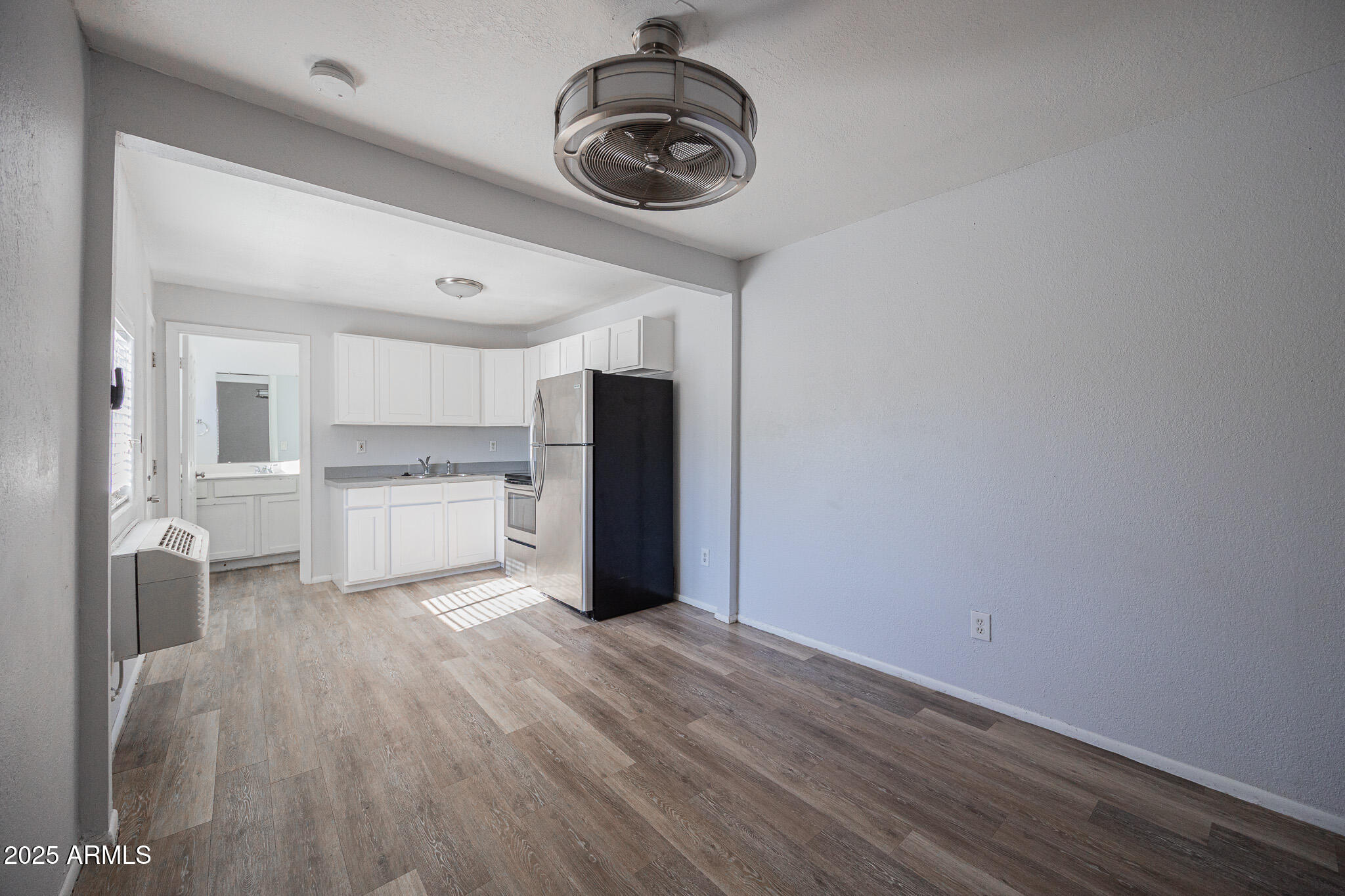 1026 East Pierce Street, Unit B Phoenix, AZ 85006 - Photo 7 of 14 a view of a kitchen with a sink wooden floor and a window
