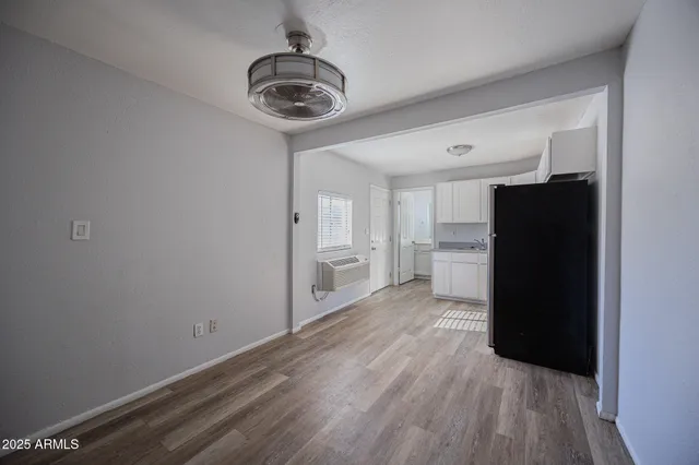 a view of a kitchen with a refrigerator and a stove top oven