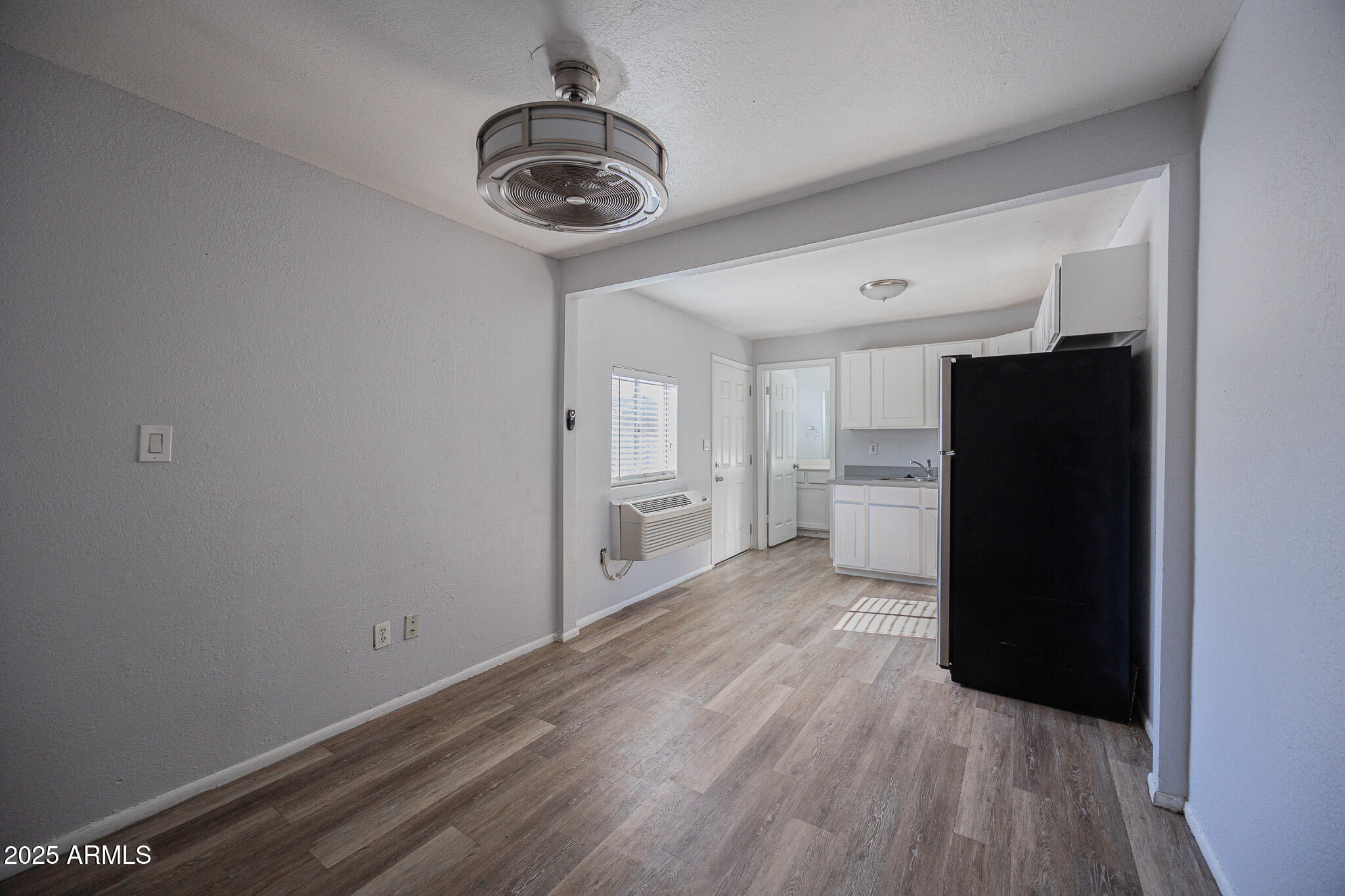 1026 East Pierce Street, Unit B Phoenix, AZ 85006 - Photo 8 of 14 a view of a kitchen with a refrigerator and a stove top oven
