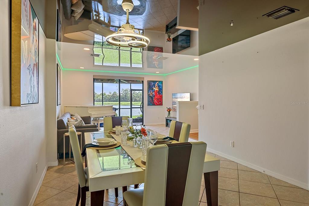 7325 Skybird Road, Unit 399 Bradenton, FL 34209 - Photo 13 of 49 a dining room with furniture and a chandelier