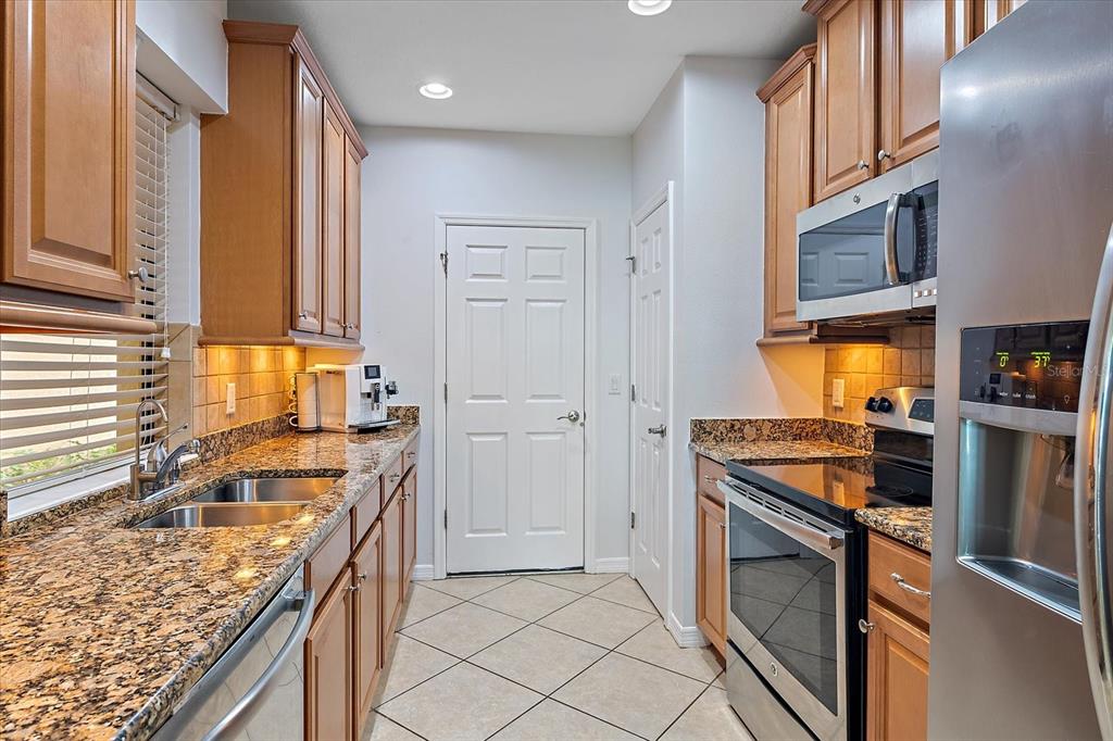 7325 Skybird Road, Unit 399 Bradenton, FL 34209 - Photo 15 of 49 a kitchen with stainless steel appliances granite countertop a sink stove and refrigerator