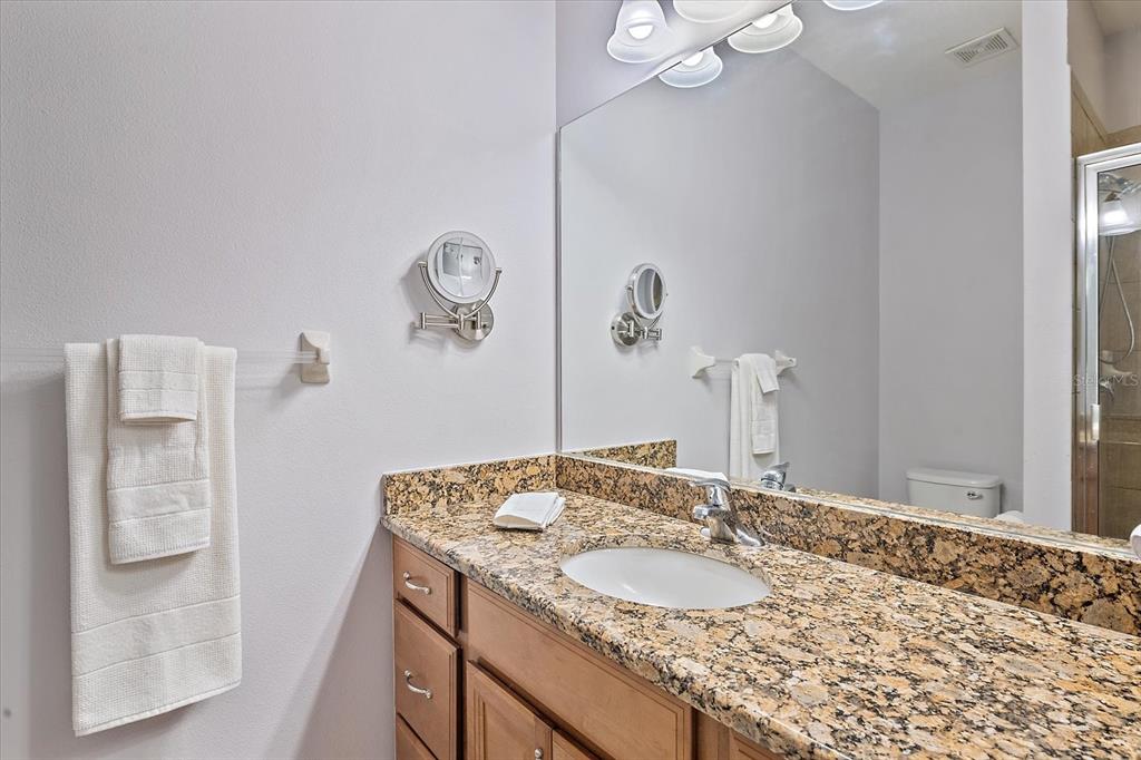 7325 Skybird Road, Unit 399 Bradenton, FL 34209 - Photo 17 of 49 a bathroom with a granite countertop sink and a mirror