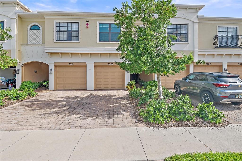 7325 Skybird Road, Unit 399 Bradenton, FL 34209 - Photo 2 of 49 a front view of a house with a yard and a garage