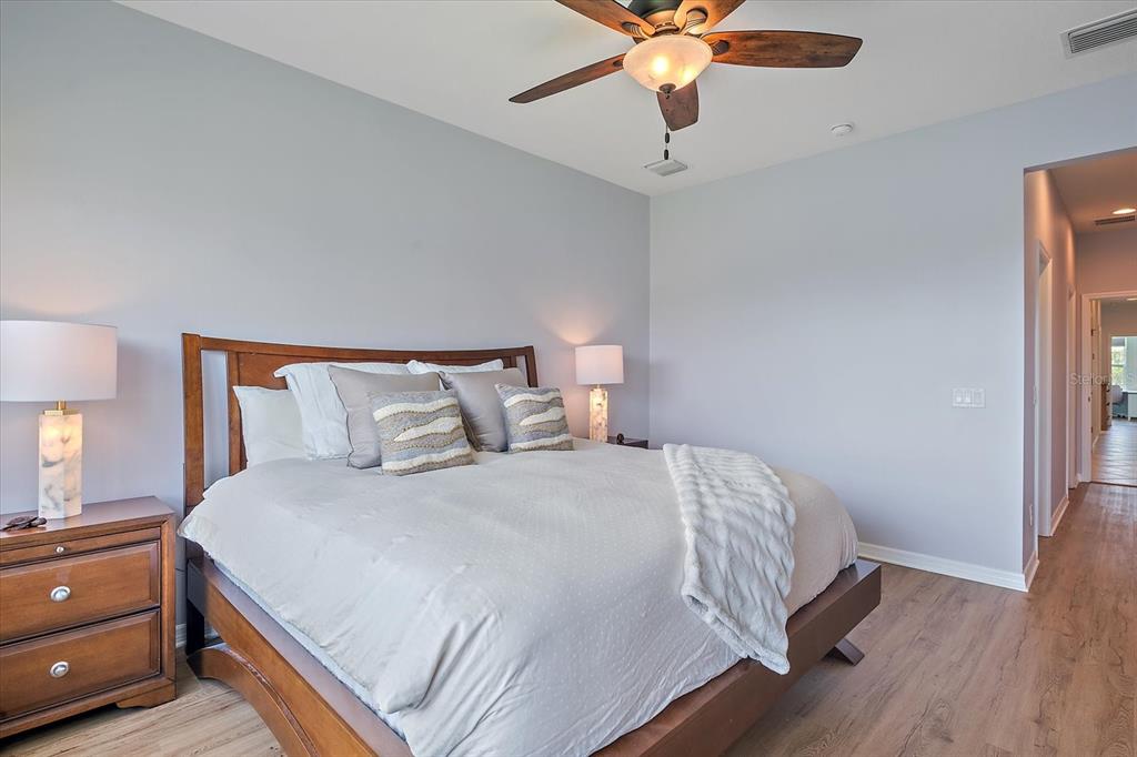 7325 Skybird Road, Unit 399 Bradenton, FL 34209 - Photo 24 of 49 a bedroom with a bed and a chandelier