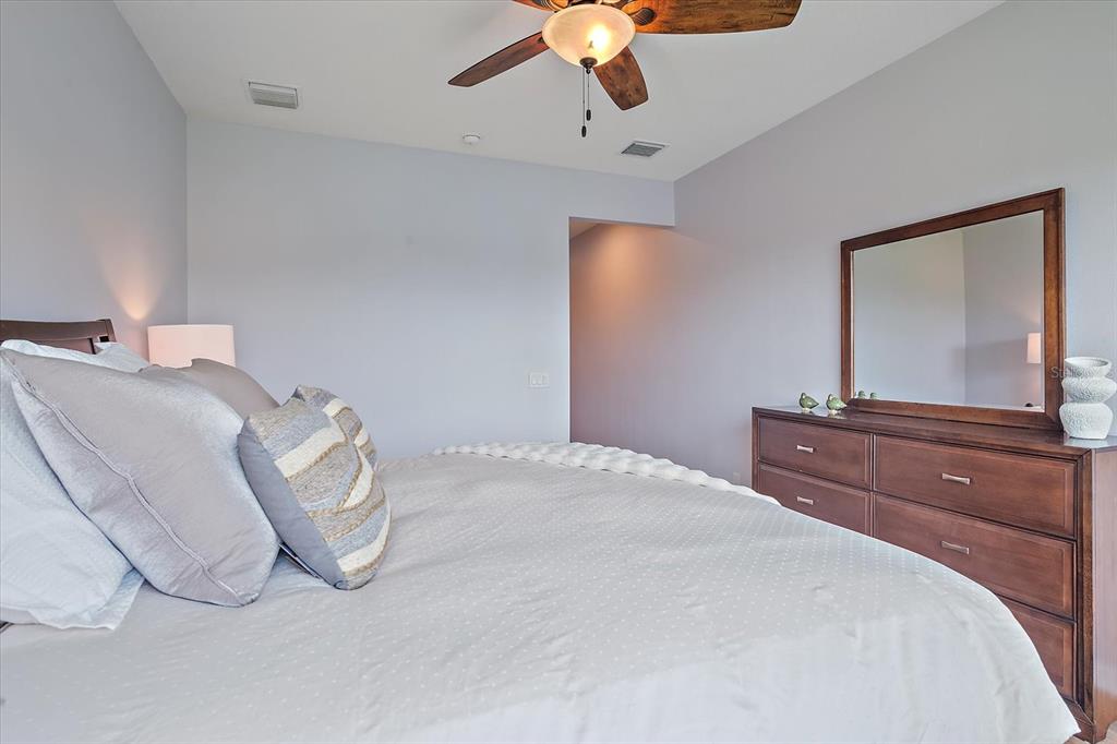 7325 Skybird Road, Unit 399 Bradenton, FL 34209 - Photo 25 of 49 a bedroom with a bed and a mirror