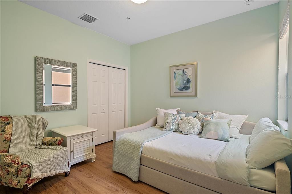 7325 Skybird Road, Unit 399 Bradenton, FL 34209 - Photo 28 of 49 a bedroom with a bed and a couch