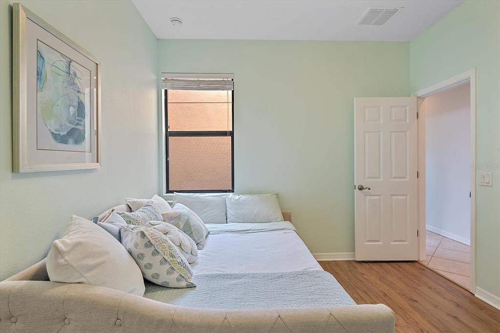 7325 Skybird Road, Unit 399 Bradenton, FL 34209 - Photo 30 of 49 a bedroom with a bed and wooden floor