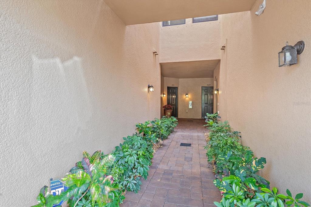 7325 Skybird Road, Unit 399 Bradenton, FL 34209 - Photo 3 of 49 a view of a pathway with a flower plants