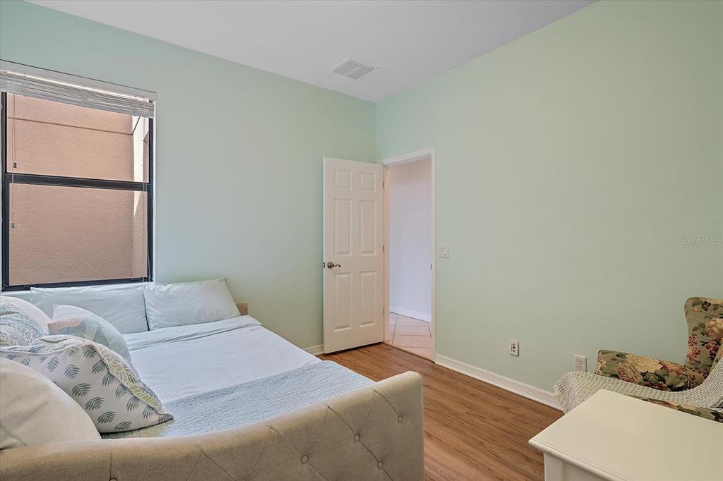 7325 Skybird Road, Unit 399 Bradenton, FL 34209 - Photo 31 of 49 a bedroom with a bed and wooden floor