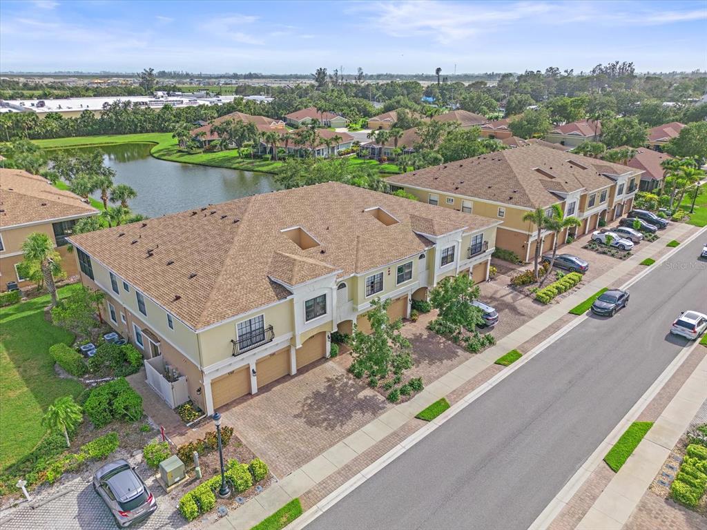 7325 Skybird Road, Unit 399 Bradenton, FL 34209 - Photo 42 of 49 an aerial view of a house with a garden and lake view