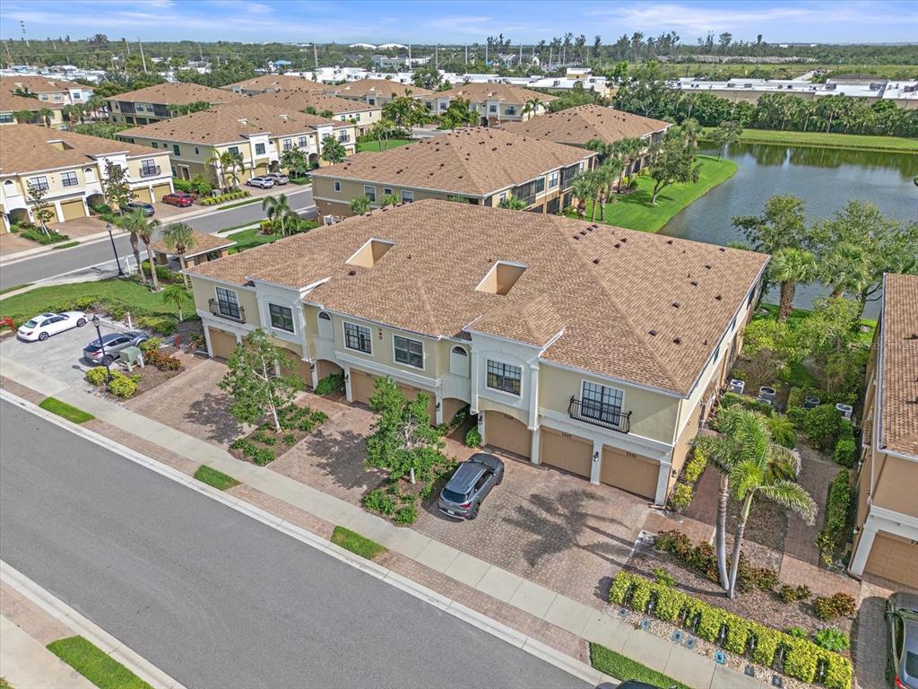 7325 Skybird Road, Unit 399 Bradenton, FL 34209 - Photo 5 of 49 an aerial view of a house with a garden and lake view