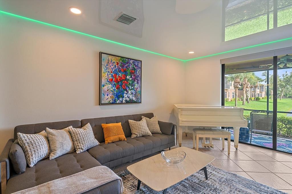 7325 Skybird Road, Unit 399 Bradenton, FL 34209 - Photo 8 of 49 a living room with furniture and a floor to ceiling window