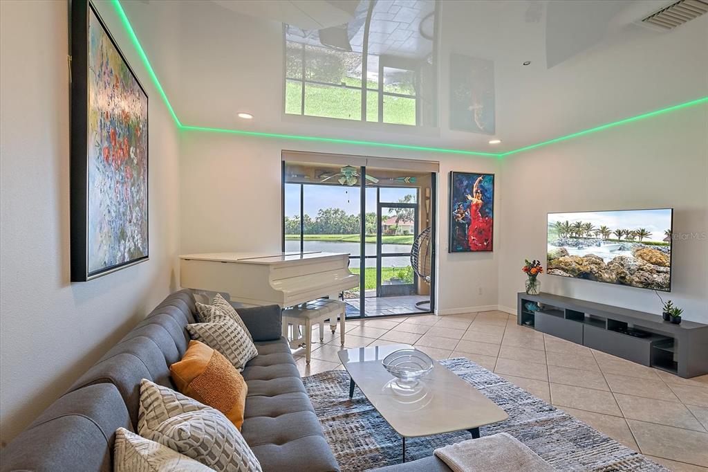 7325 Skybird Road, Unit 399 Bradenton, FL 34209 - Photo 10 of 49 a living room with furniture and a flat screen tv