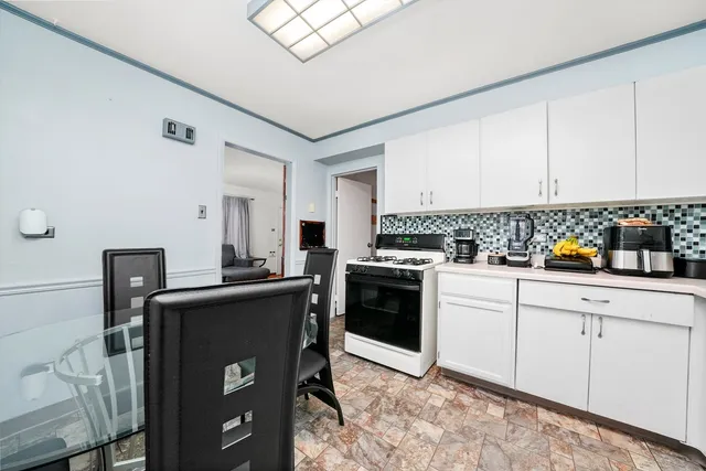 a kitchen with granite countertop a sink appliances cabinets and counter space