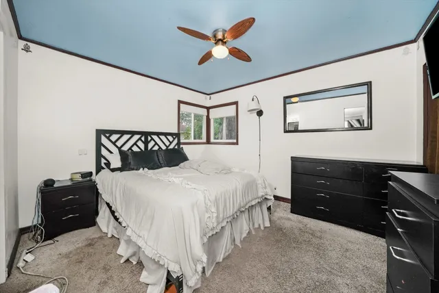 a bedroom with a bed and a tv