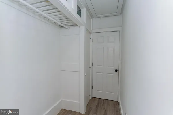 an empty room with a window and a ceiling fan