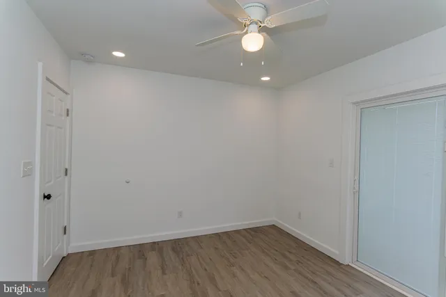 a view of a hallway with wooden floor and entryway