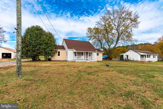 a front view of a house with a big yard