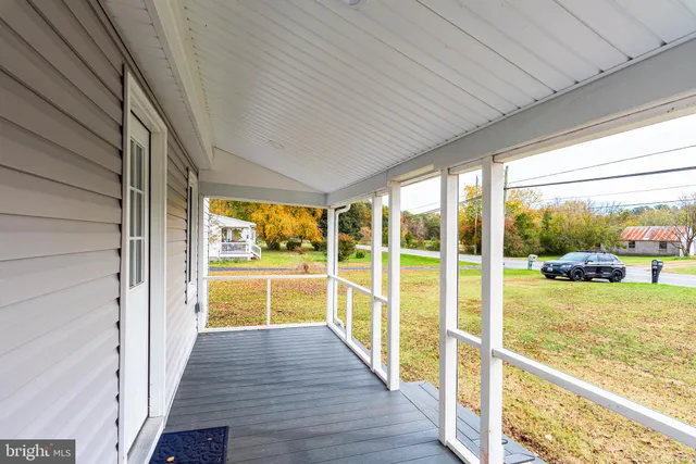 a front view of a house with a garden and tree