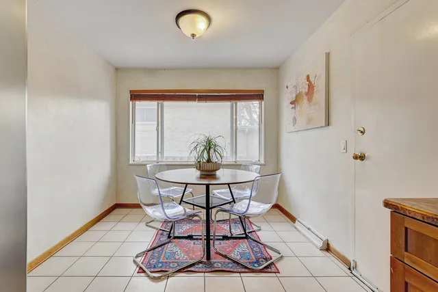 a view of a dining room with furniture and window