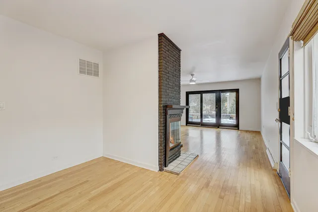 a view of hallway with wooden floor and stairs
