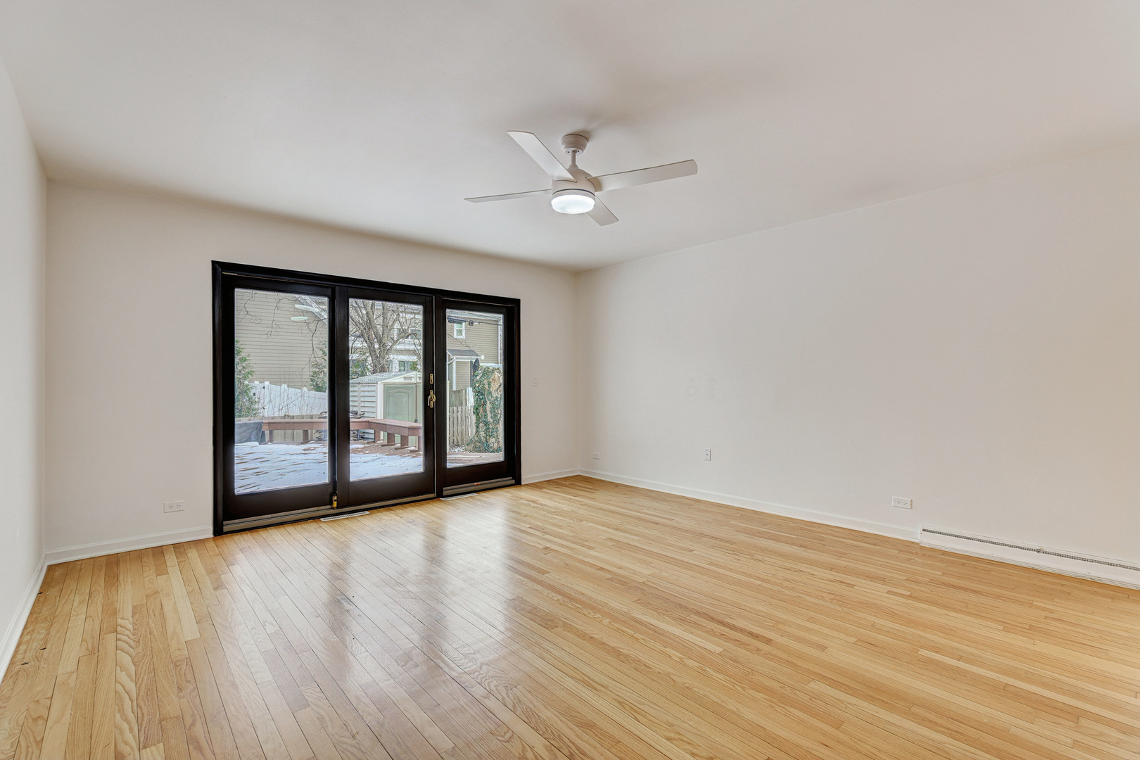 1343 Oxford Road Deerfield, IL 60015 - Photo 14 of 28 wooden floor in an empty room with a window