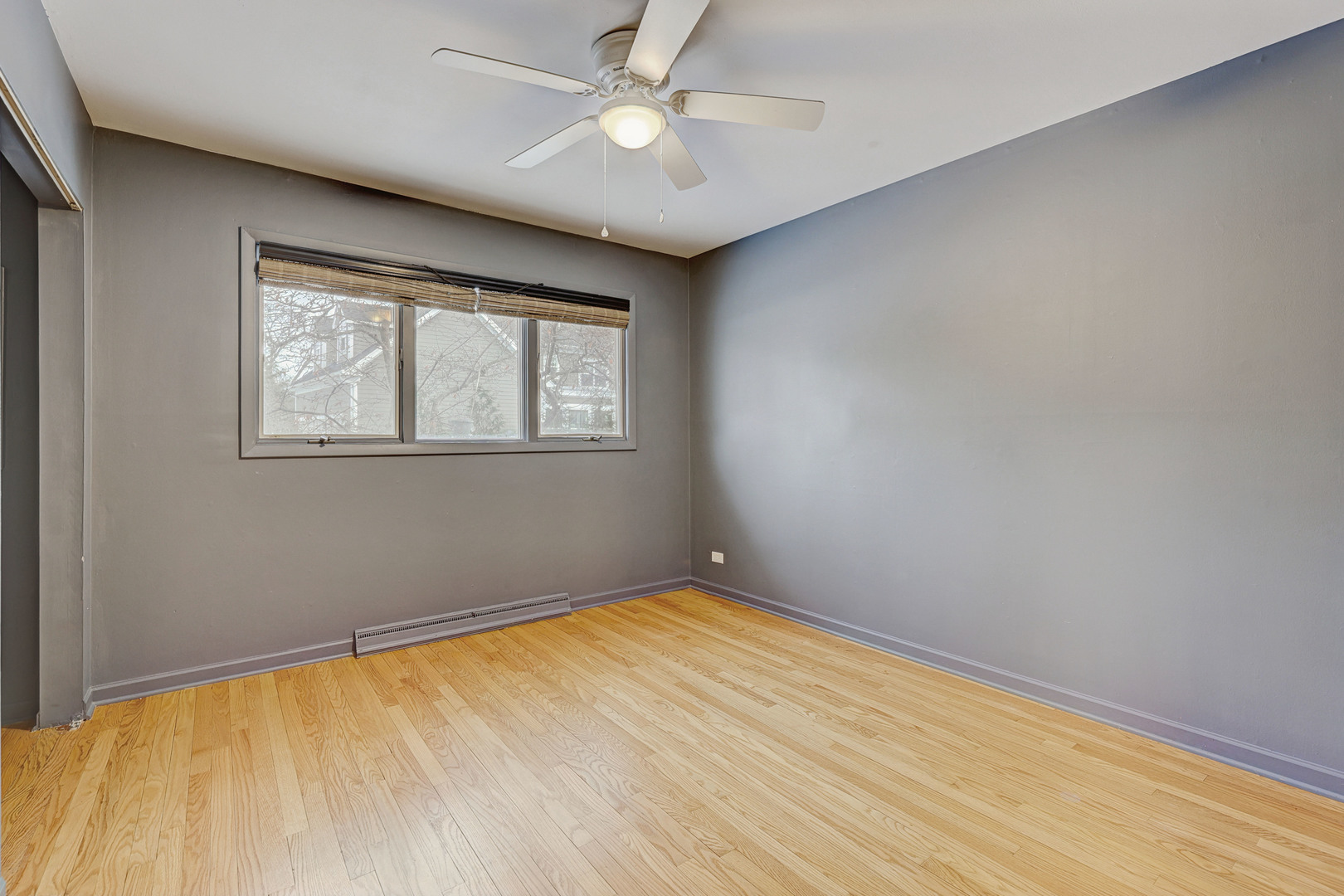 1343 Oxford Road Deerfield, IL 60015 - Photo 17 of 28 wooden floor in an empty room with a window