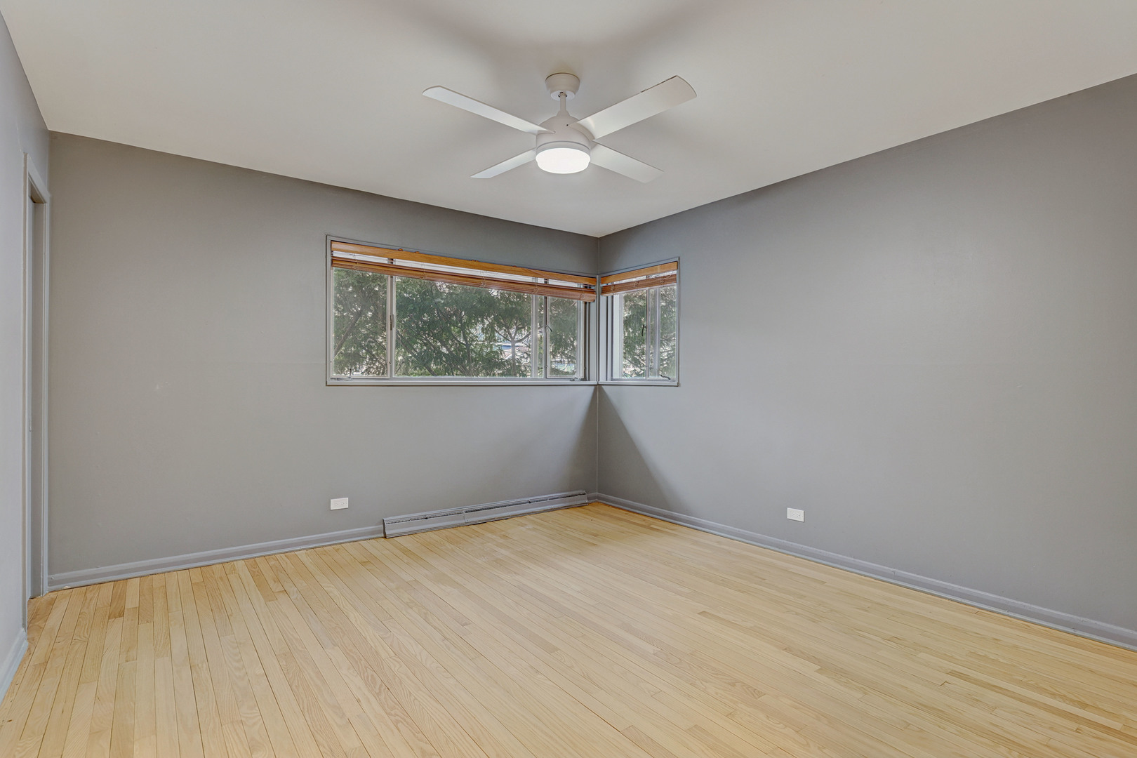 1343 Oxford Road Deerfield, IL 60015 - Photo 19 of 28 wooden floor in an empty room with a window