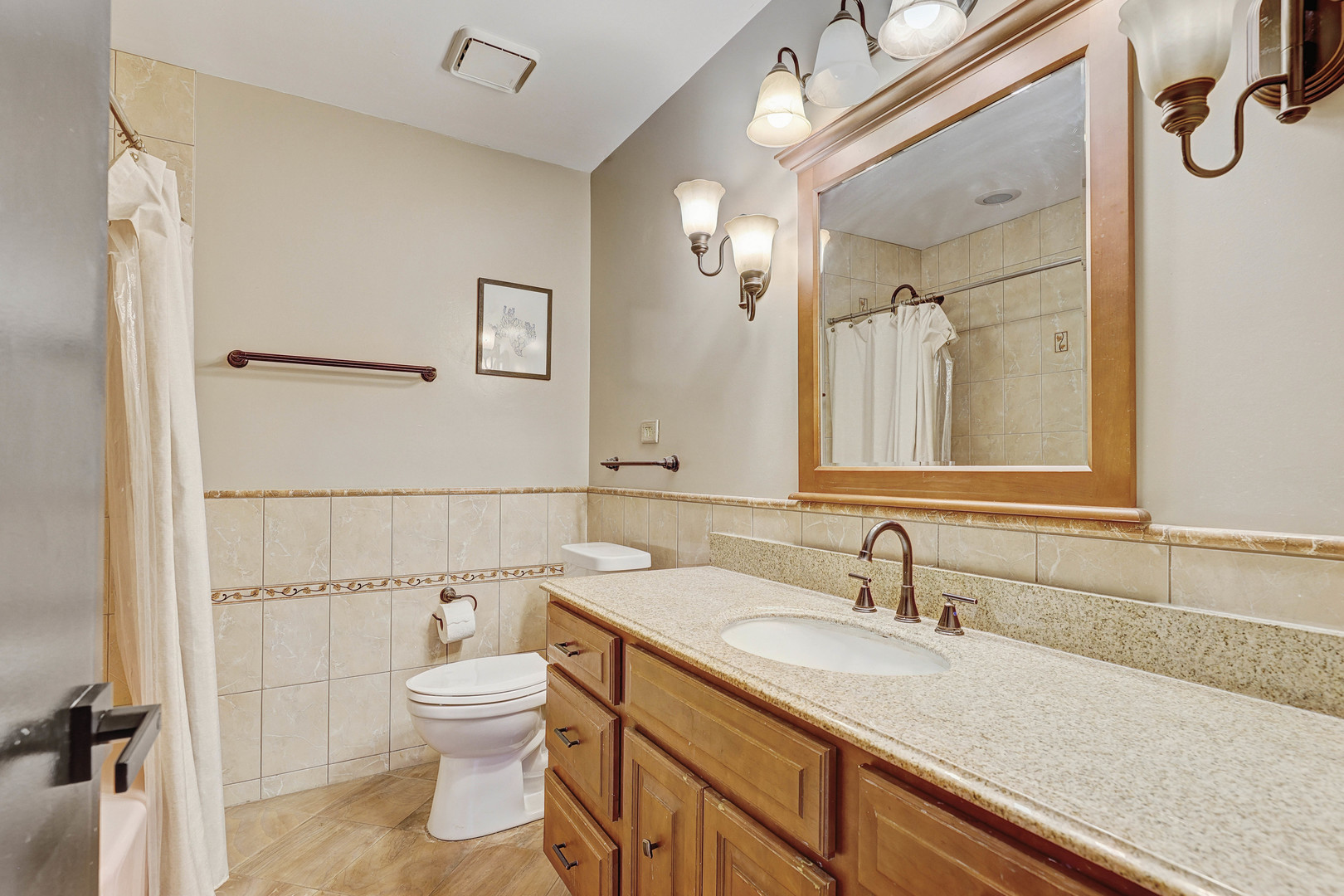 1343 Oxford Road Deerfield, IL 60015 - Photo 23 of 28 a bathroom with a granite countertop sink mirror vanity and toilet