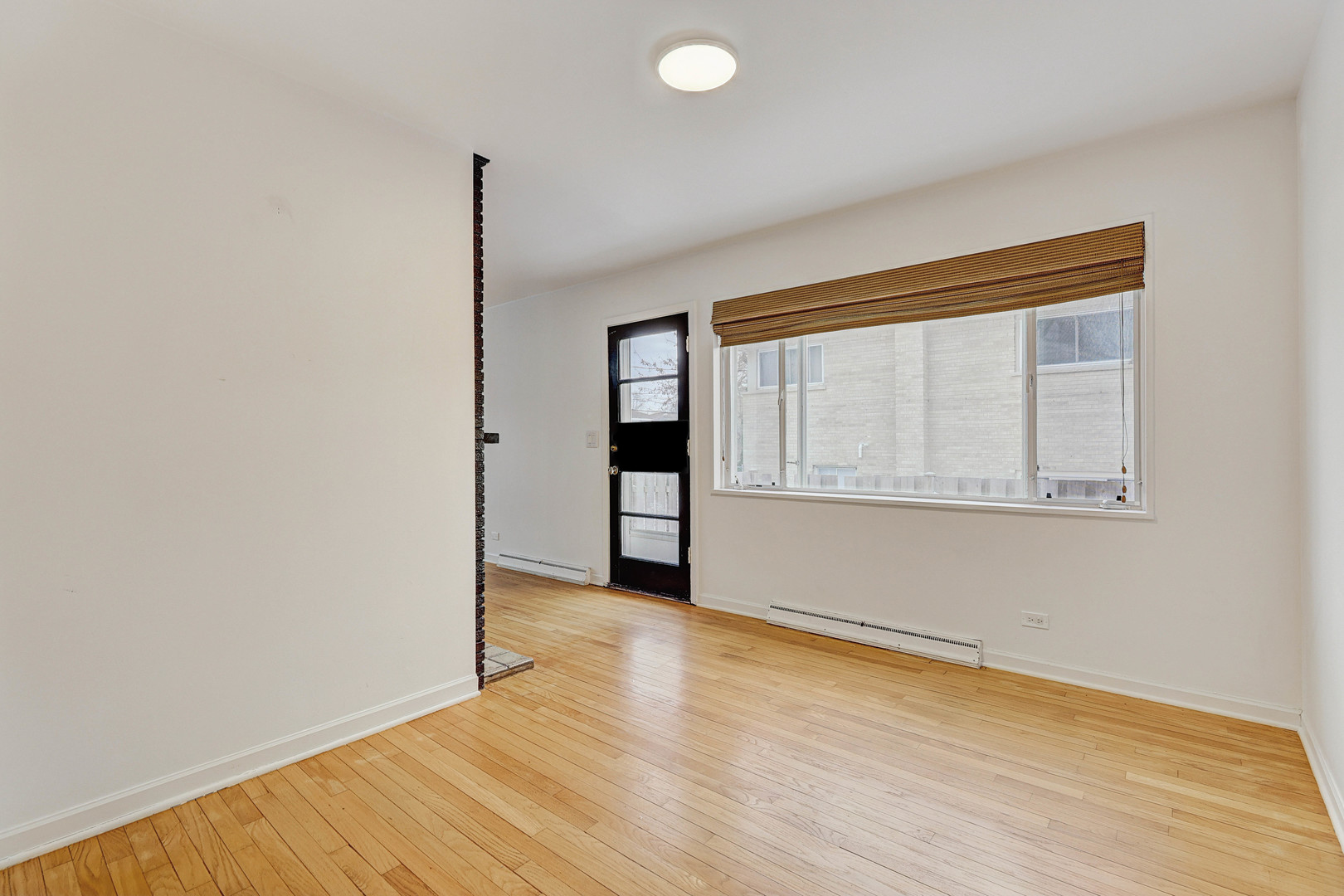 1343 Oxford Road Deerfield, IL 60015 - Photo 3 of 28 an empty room with wooden floor and windows