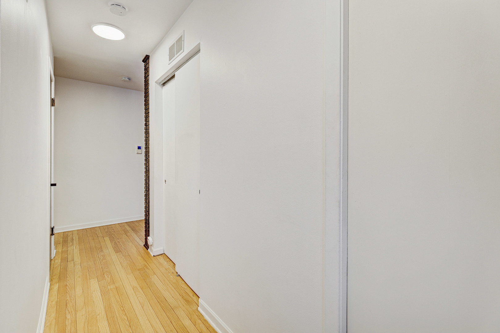 1343 Oxford Road Deerfield, IL 60015 - Photo 6 of 28 a view of a room with wooden floor and a bathroom