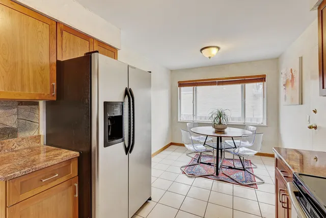 a kitchen with stainless steel appliances granite countertop a refrigerator and a stove top oven