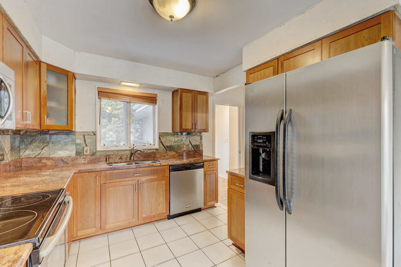 1343 Oxford Road Deerfield, IL 60015 - Photo 10 of 28 a kitchen with stainless steel appliances granite countertop a refrigerator and a sink