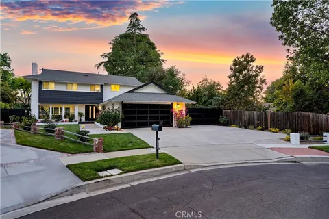a view of a house with backyard sitting area and garden