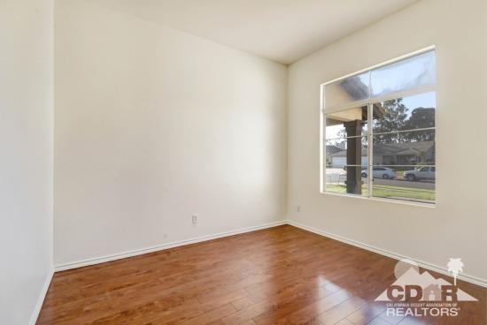841 Homestead Road Corona, CA 92878 - Photo 14 of 21 an empty room with wooden floor and a window