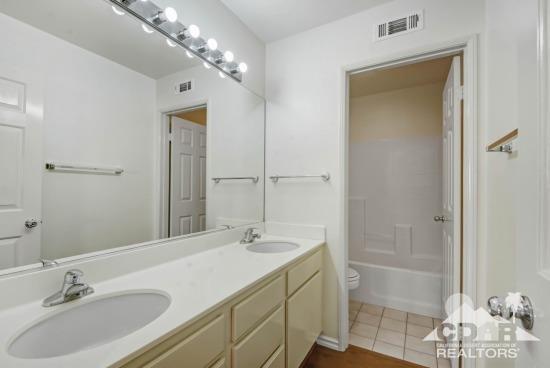 841 Homestead Road Corona, CA 92878 - Photo 17 of 21 a bathroom with a sink double vanity and shower