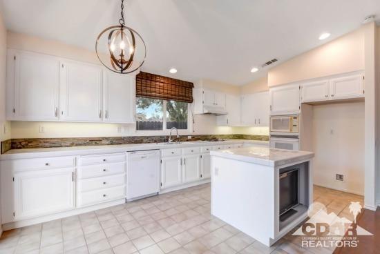 841 Homestead Road Corona, CA 92878 - Photo 5 of 21 a kitchen with granite countertop cabinets stainless steel appliances and a fireplace