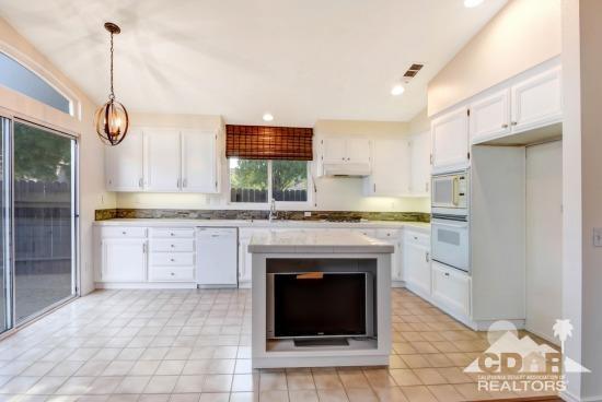 841 Homestead Road Corona, CA 92878 - Photo 7 of 21 a open kitchen with granite countertop a stove a sink and a refrigerator