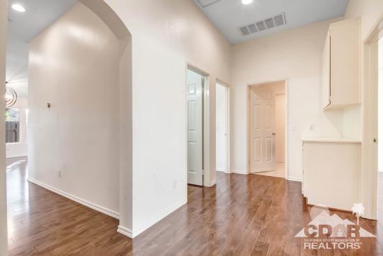 841 Homestead Road Corona, CA 92878 - Photo 9 of 21 a view of a hallway with wooden floor