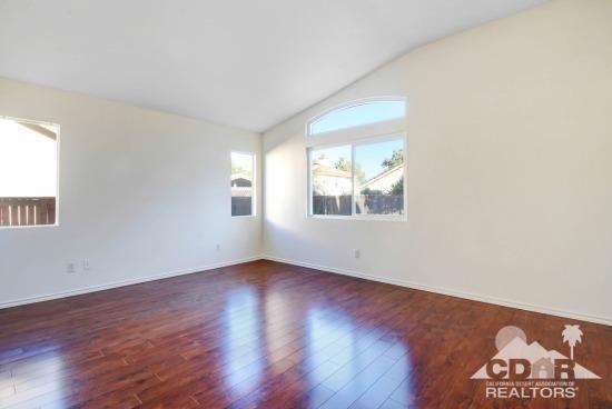 841 Homestead Road Corona, CA 92878 - Photo 10 of 21 an empty room with wooden floor and windows