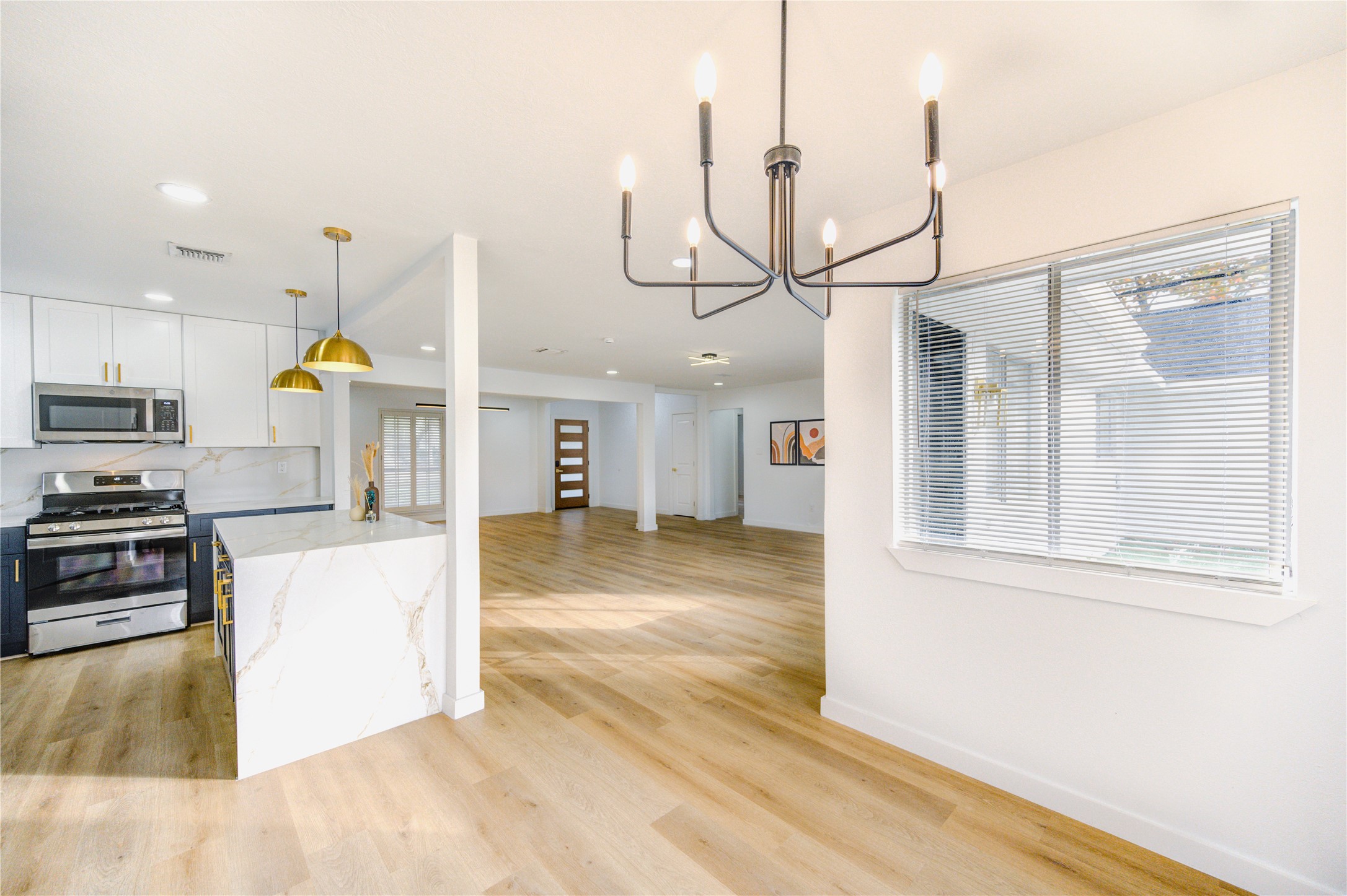 25607 Spring Ridge Drive Spring, TX 77386 - Photo 14 of 50 a view of a kitchen with kitchen island a counter top space cabinets stainless steel appliances and a window