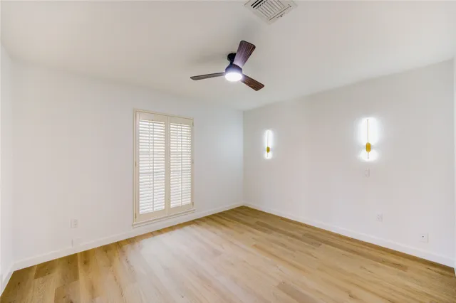 a spacious bathroom with a double vanity sink and a mirror