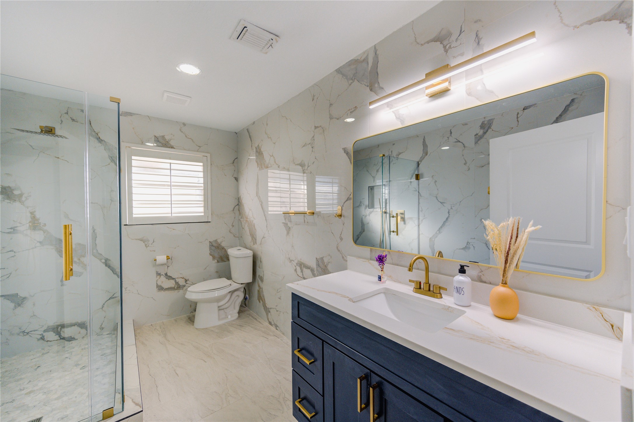 25607 Spring Ridge Drive Spring, TX 77386 - Photo 24 of 50 Luxurious bathrooms with floor to ceiling tiles, standing shower with elegant fixtures, modern vanity, and ADA accessible door